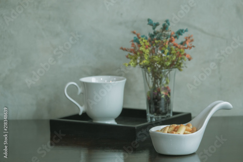 Coffee cup with flower in vintage style. © Golden House Images
