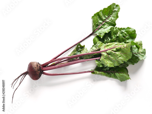Fresh beets with tops isolated on a white background, top view.