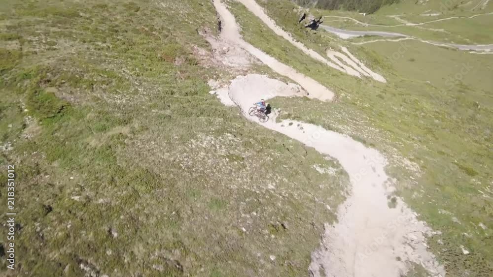 Mountain bikers race down dirt trails in Verbier, Switzerland. Mountain bikers race down dirt trails in Verbier, Switzerland.