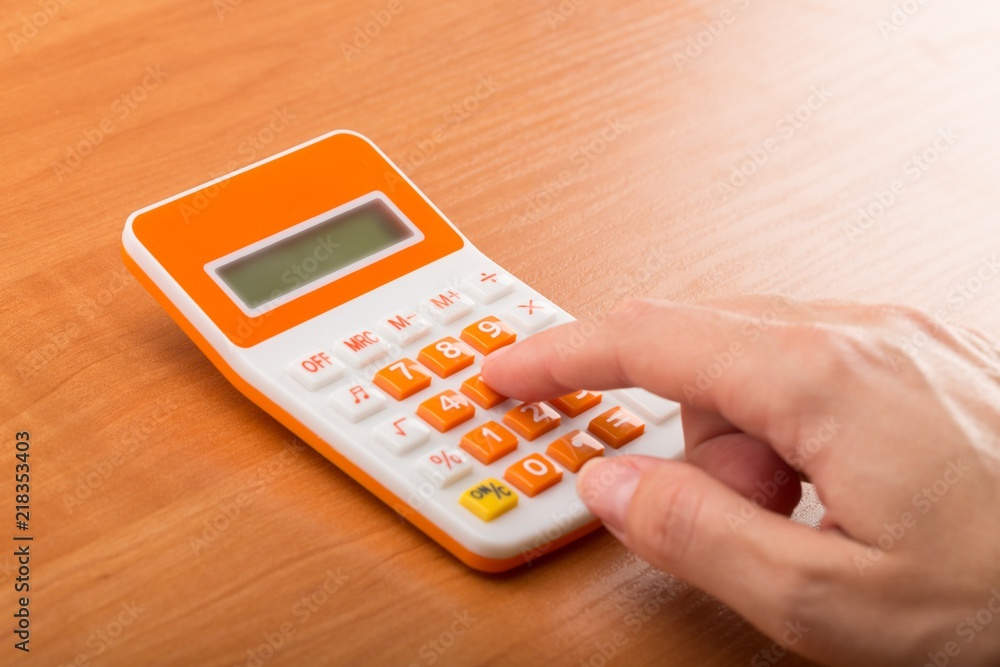 Close-up of a Woman Using Calculator Close-up of a Woman Using Calculator