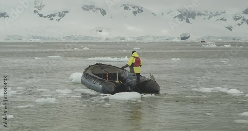 A zodiac maneuverers between small ice bergs in Antarctica. photo