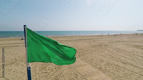 Green flag on the Mediterranean beach