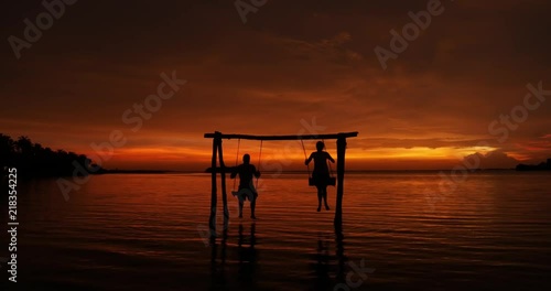 Wallpaper Mural 2 people on swings in a Sri Lankan sunset Torontodigital.ca