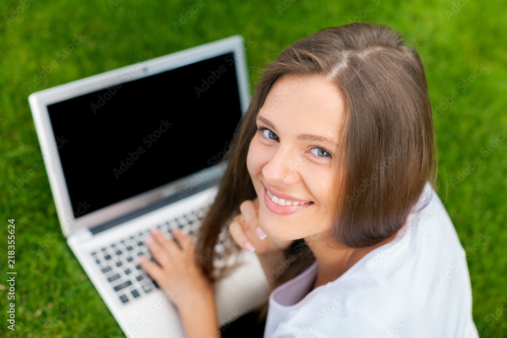 Portrait of a Young Woman Using her Laptop in a Park Portrait of a Young Woman Using her Laptop in a Park