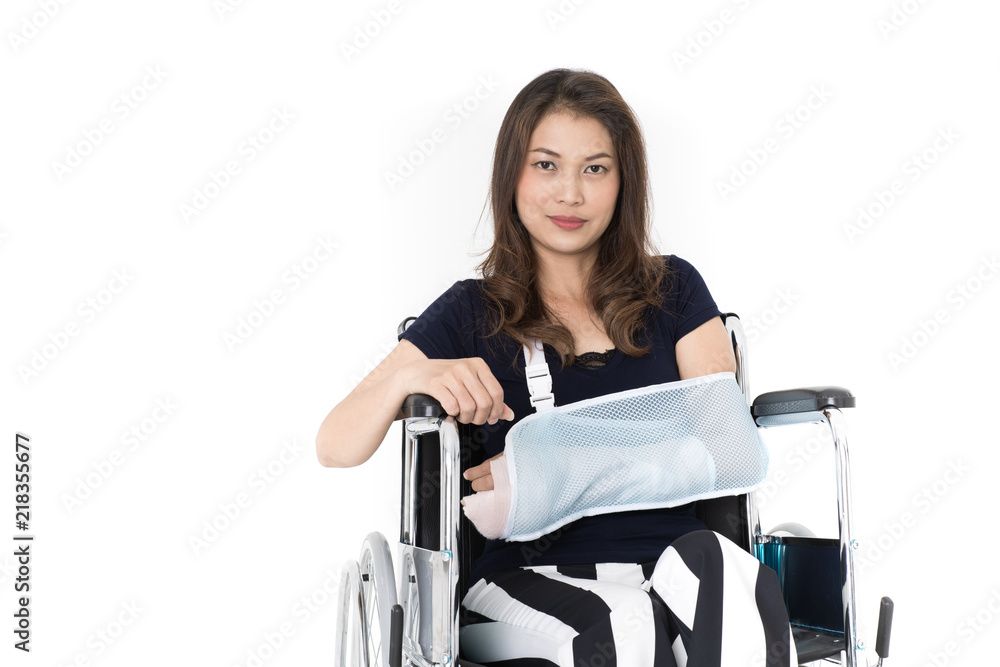 Broken arm Asian woman with arm sling sponsored in her hands sitting on a wheelchair Ideas for accident Injuries and health care Studio shot on white background. Broken arm Asian woman with arm sling sponsored in her hands sitting on a wheelchair Ideas for accident Injuries and health care Studio shot on white background.