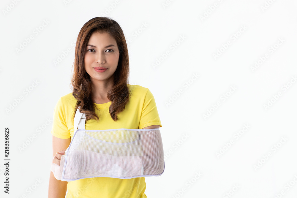 Arm broken Asian woman with arm sling supported on her hand, concept for injured by accident and healthcare. Studio shot a white background. Arm broken Asian woman with arm sling supported on her hand, concept for injured by accident and healthcare. Studio shot a white background.