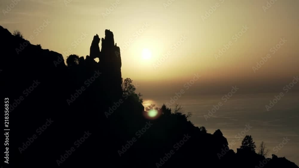 Sunset behind a heart rock shaped hole. Sunset behind a heart rock shaped hole.
