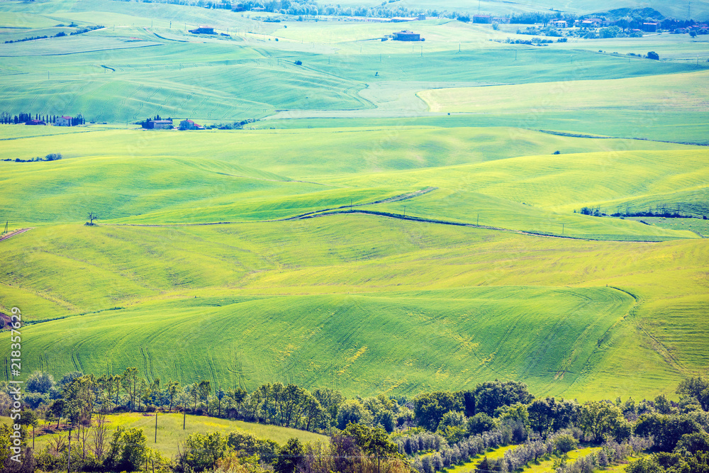 Beautiful landscape, spring nature. View from above of sunny fields on rolling hills in Tuscany, Italy