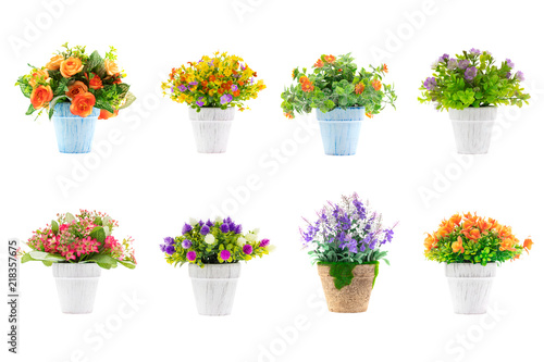 Rows of colorful fake flowers on white background, made from cloth and plastic for decoration.