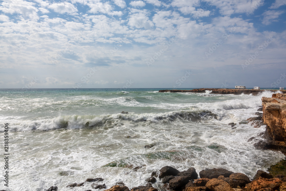 White ocean waves crashing to rocks