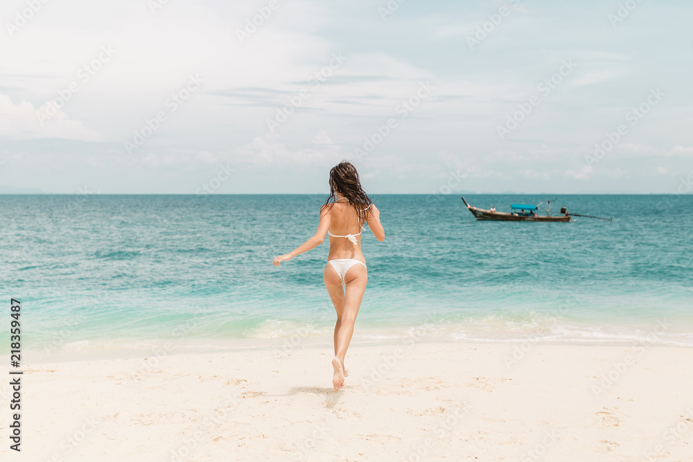 Young girl in bikini posing and smiling on a beach of Thailand Young girl in bikini posing and smiling on a beach of Thailand
