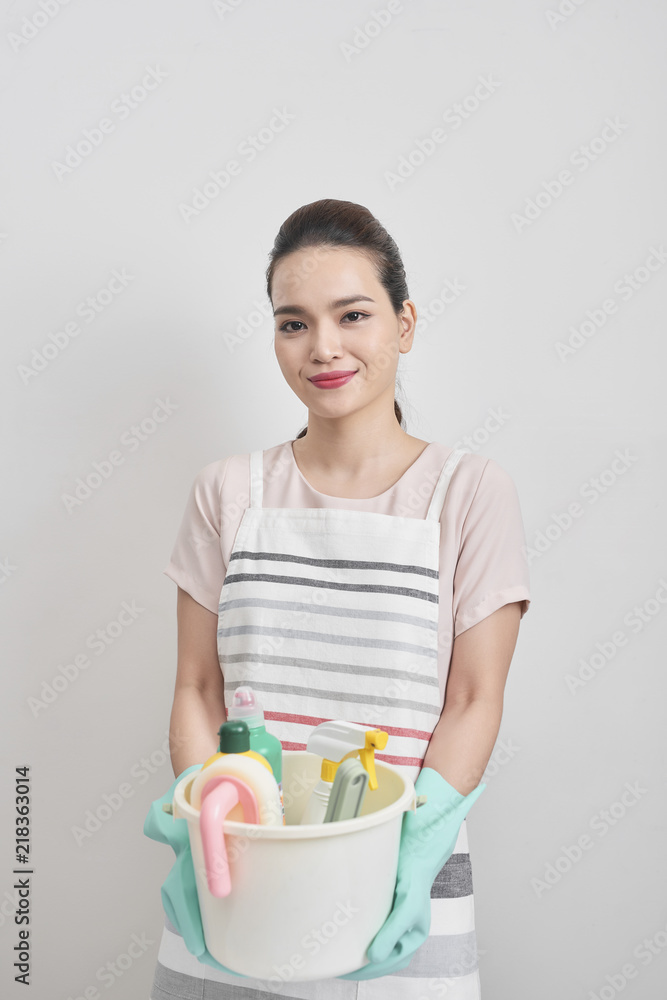 people, housework and housekeeping concept - happy woman holding cleaning stuff at home people, housework and housekeeping concept - happy woman holding cleaning stuff at home