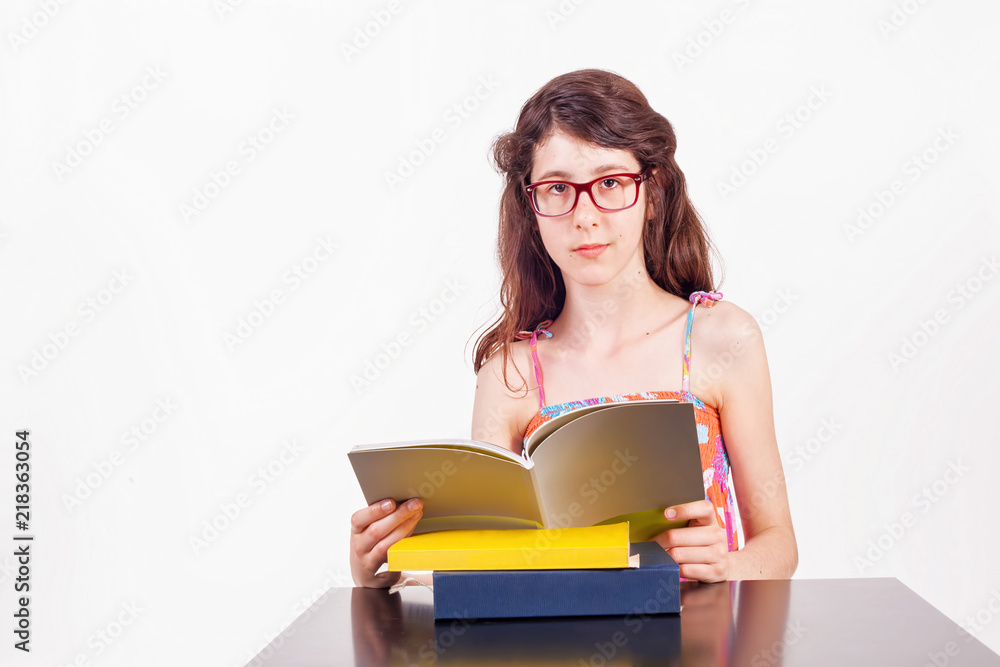 Teenage girl sitting at the table studying Teenage girl sitting at the table studying