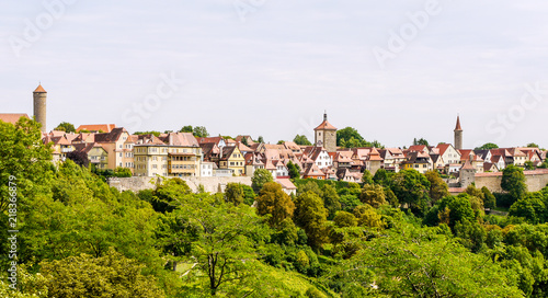 Scene from Rothenburg Ob Der Tauber, showing the whole city from far away, with the city wall, watch towers and houses visible. © Michaella