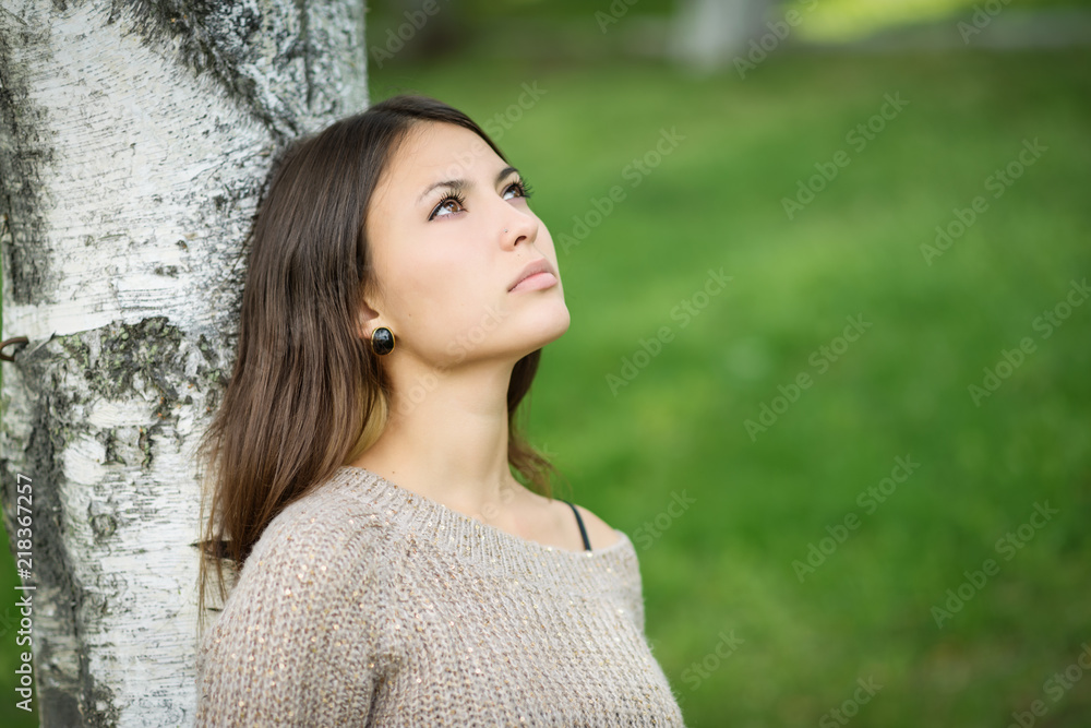 Portrait of young woman leaned to the birch tree. Portrait of young woman leaned to the birch tree.