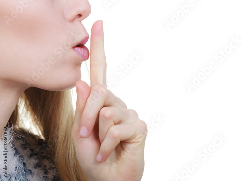 Woman making silence gesture with finger