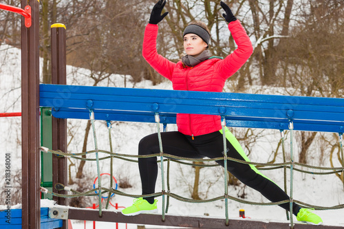 Fototapeta Naklejka Na Ścianę i Meble -  Woman wearing sportswear urban exercising outside during winter