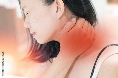 Neck pain disease concept. Asian female hand on her neck as suffering from office syndrome neck ache