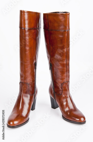 Female long brown shoes isolated on white background.