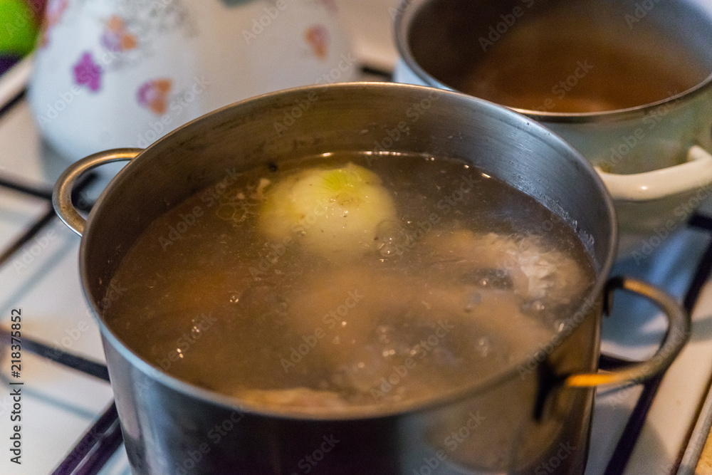 Boiling of traditional Fish soup in iron pan, selective focus Boiling of traditional Fish soup in iron pan, selective focus