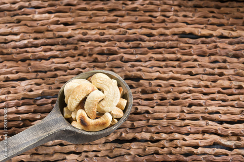 Natural and roasted cashew nut on wooden background - Anacardium occidentale photo