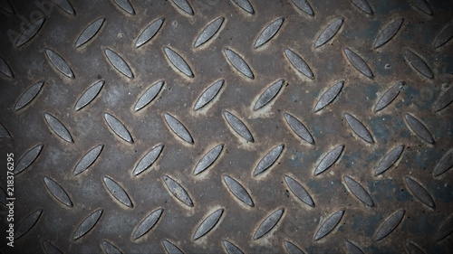 Steel sheet with notches - gray vintage metal background, texture. Square neutral background with vignette