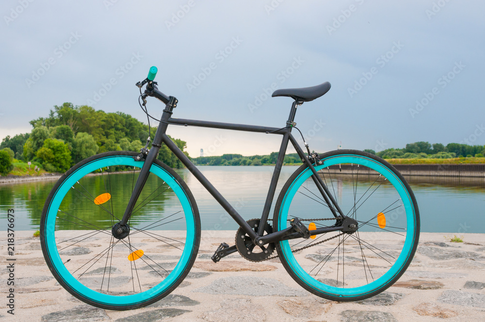 Fixed bicycle  by the river. Tranquil landscape