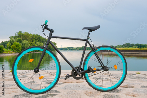 Fixed bicycle by the river. Tranquil landscape