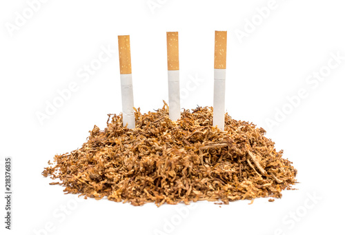 Pile of cut tobacco with cigarettes on white background.