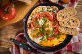 Homemade breakfast fried egg with tomato.