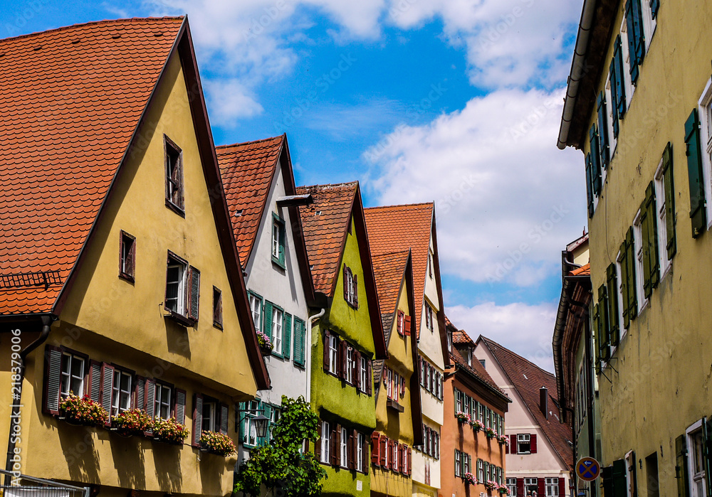 Brightly colored houses in a German town, showing beautiful traditional architecture and blue skies. Taken on a summer day in Dinkelsbühl, Bavaria. Brightly colored houses in a German town, showing beautiful traditional architecture and blue skies. Taken on a summer day in Dinkelsbühl, Bavaria.