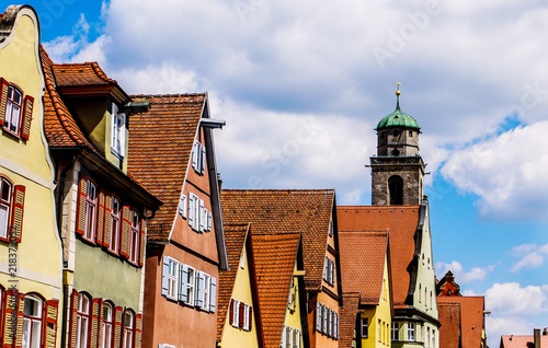 Brightly colored houses in a German town, showing beautiful traditional architecture and blue skies. Taken on a summer day in Dinkelsbühl, Bavaria.