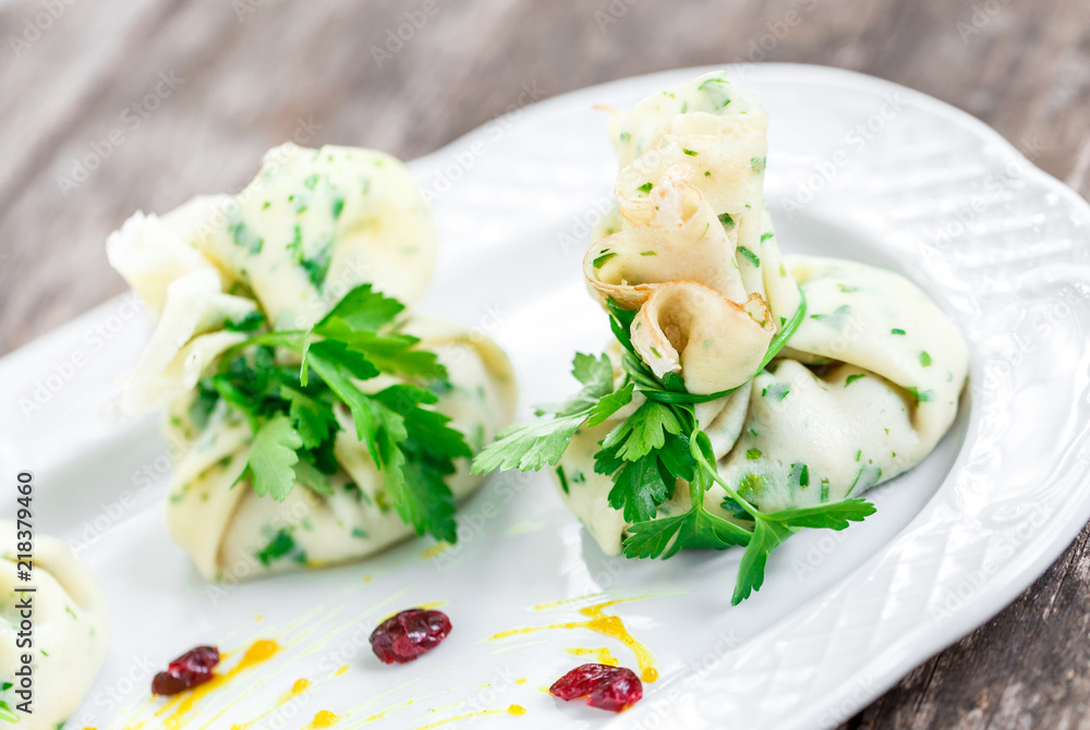 Stuffed pancakes or bags of pancakes with herbs on plate on rustic table. Healthy food Stuffed pancakes or bags of pancakes with herbs on plate on rustic table. Healthy food