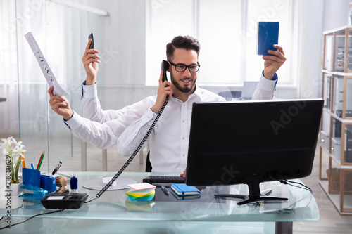 Young Businessman Doing Multitasking Work photo