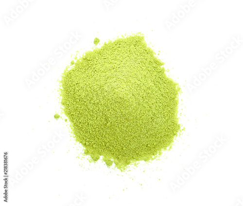 Powdered matcha green tea scattered on white background.