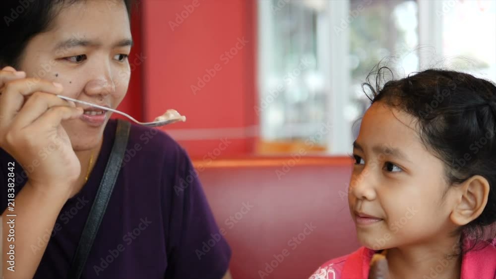 4K Slow motion Asian mother feeding ice cream to daughter little girl with happiness 4K Slow motion Asian mother feeding ice cream to daughter little girl with happiness