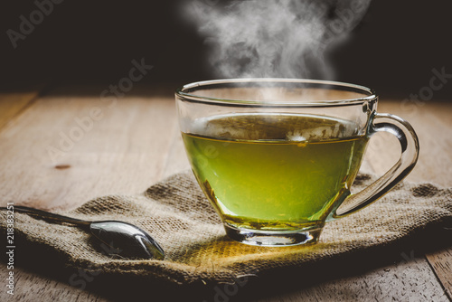 Close-up a cup of green tea on sackcloth, hot drink with steam