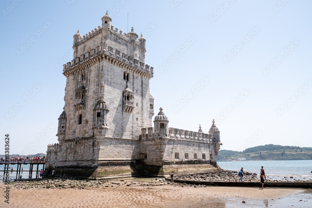 Torre de Belem, Lisboa, Portugal. The popular Lisbon landmark, The Belem Tower on the Tagus River with a line of tourists waiting to enter. Torre de Belem, Lisboa, Portugal. The popular Lisbon landmark, The Belem Tower on the Tagus River with a line of tourists waiting to enter.