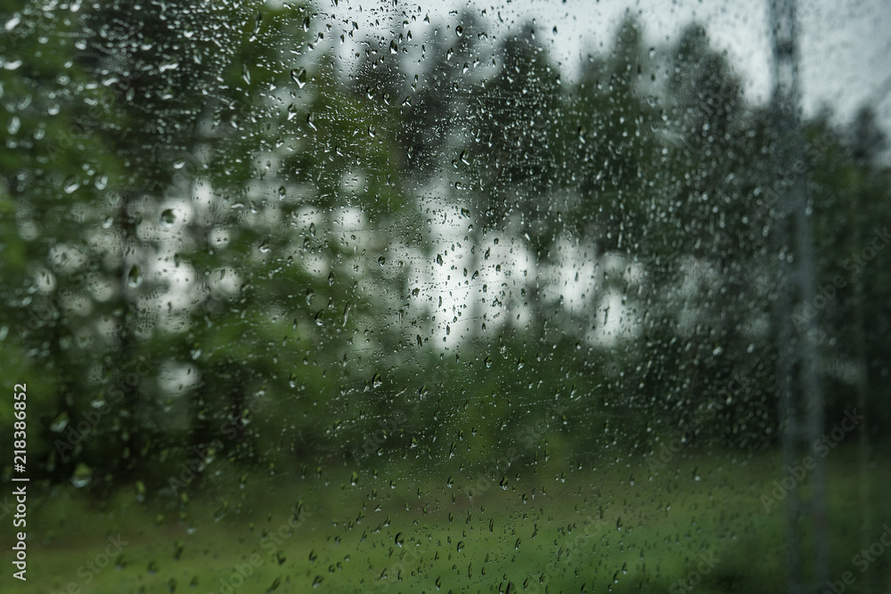 Drops on the glass on the train. On a long trip heavy rain