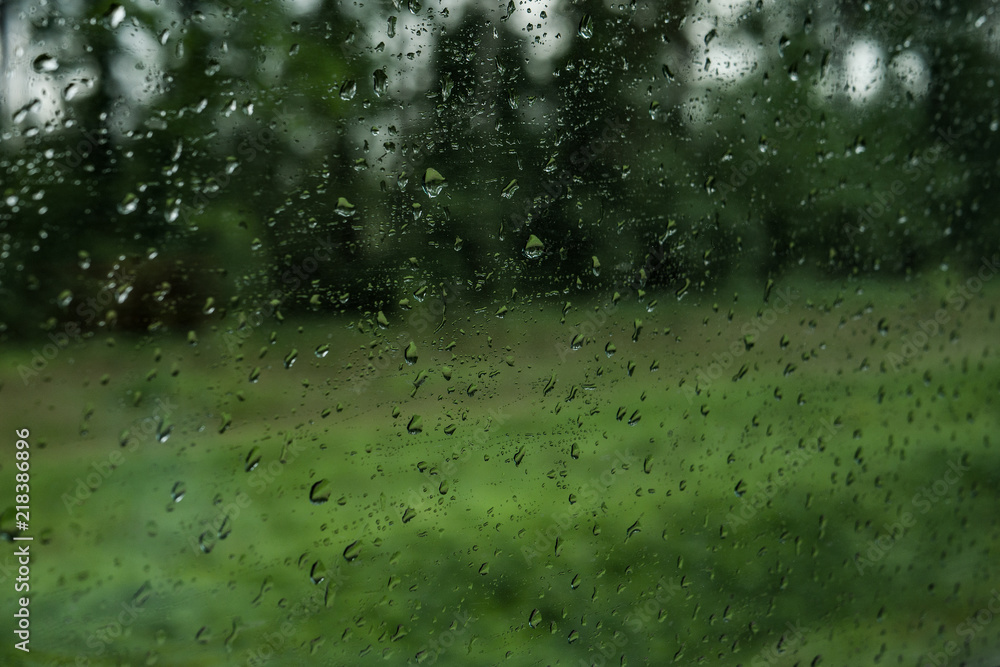 Drops on the glass on the train. On a long trip heavy rain