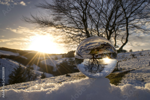 Glass ball perched on top of ice