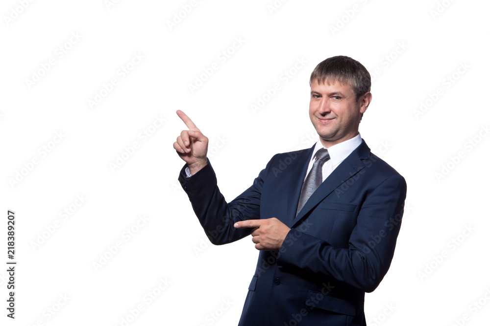 Young handsome businessman with beaming smile pointing with finger Young handsome businessman with beaming smile pointing with finger