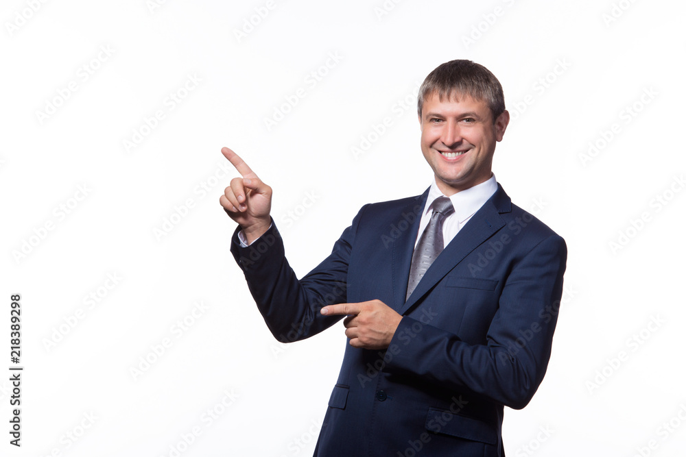 Young handsome businessman with beaming smile pointing with finger Young handsome businessman with beaming smile pointing with finger