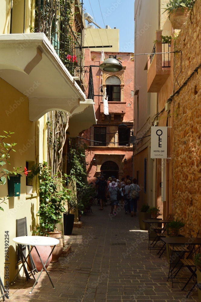 Fototapeta premium Narrow Streets In The Venetian Style Neighborhood Of Chania With Souvenir Shops. History Architecture Travel. July 6, 2018. Chania, Crete Island. Greece.
