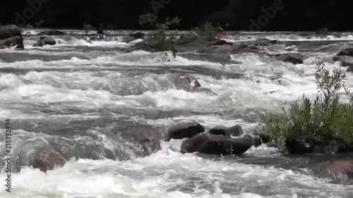rushing river with kayakers