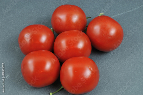 red tomatoes on a slate plate