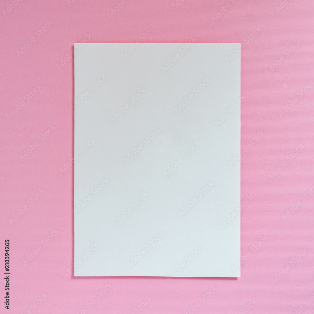 Sheet of white empty paper on a pink background, top view. Flat lay Sheet of white empty paper on a pink background, top view. Flat lay