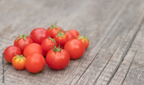 Cherry tomatoes on a wooden background. Autumn harvesting.