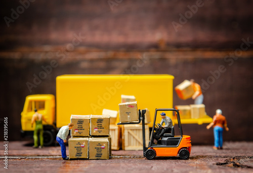 miniature warehouse workers forklift carrying goods box to semi truck with trailer .logistics warehouse freight transportation concept