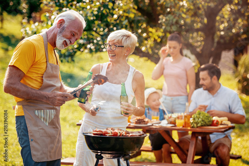 Happy family with barbecue outdoors